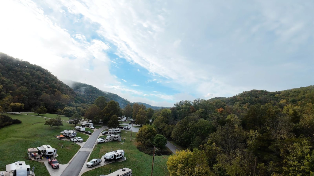 Aerial drone photograph of a scenic campground in Missouri with RVs, trees, and open landscape captured for marketing and advertising purposes.
